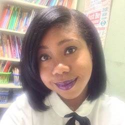 Dee Fogarty, a woman in a white shirt and tie, finds herself engrossed in a book within the library.