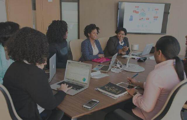 A group of people sitting around a conference table.